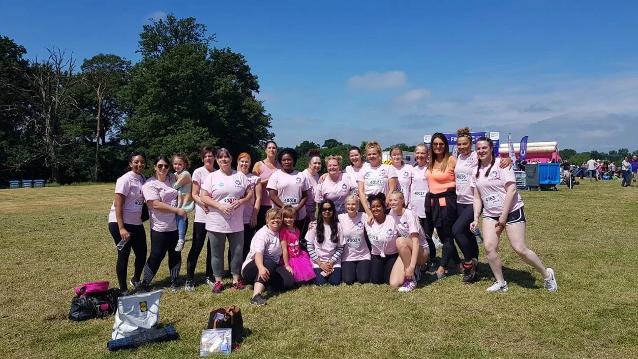 A team picture of Abbots Care staff at an event in a field