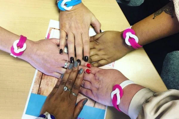 Five Abbots Care providers holding hands