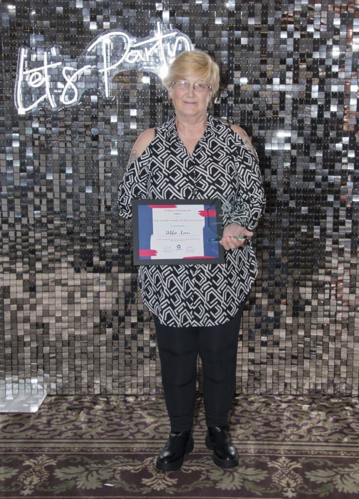 A care provider with her certificate at the Abbots Care Awards