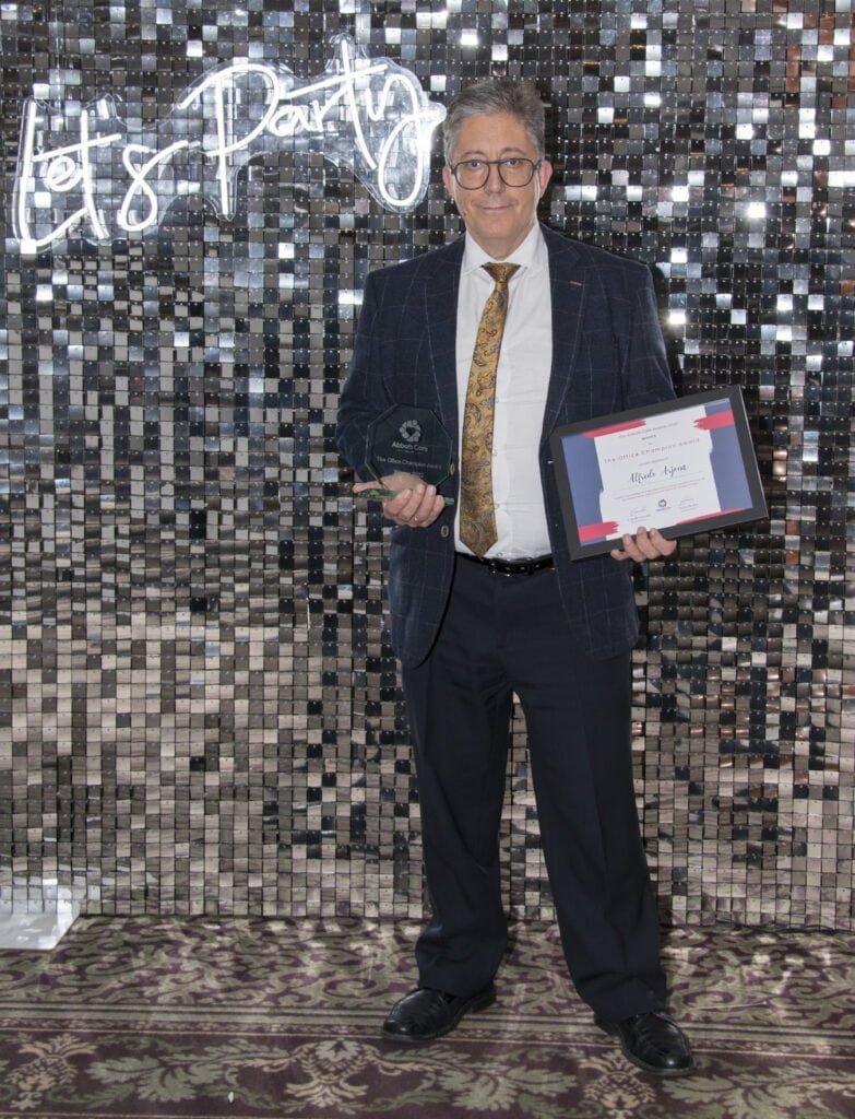 A man with a trophy and certificate at the Abbots Care Awards for home care provider services