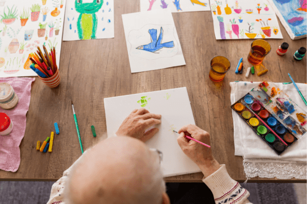 Elderly person painting different picture