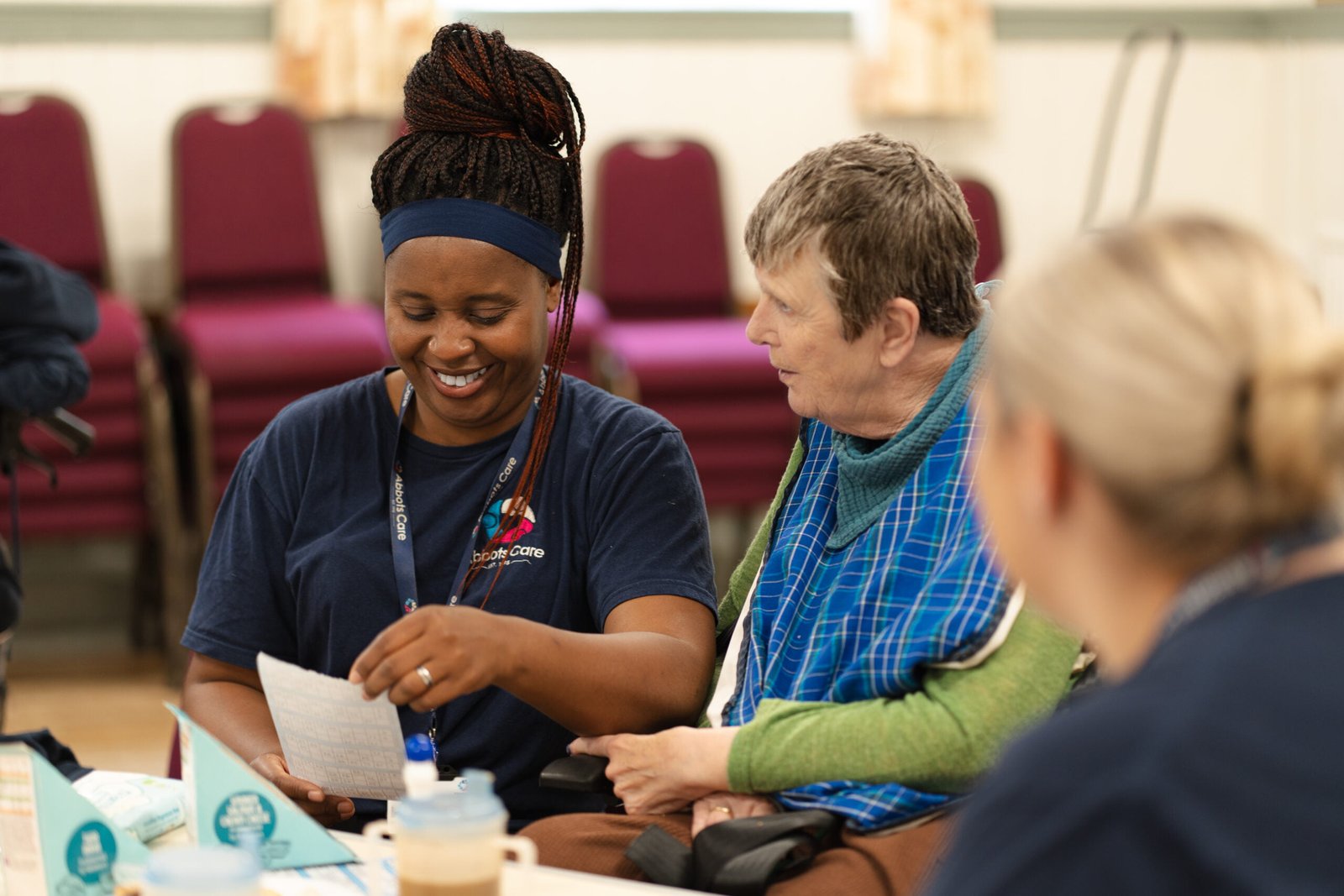 Care worker with our client at a tea party by Abbots Friends