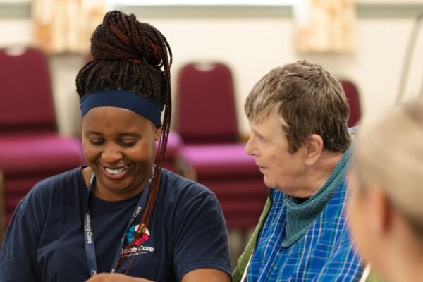 A care worker and client at a tea party