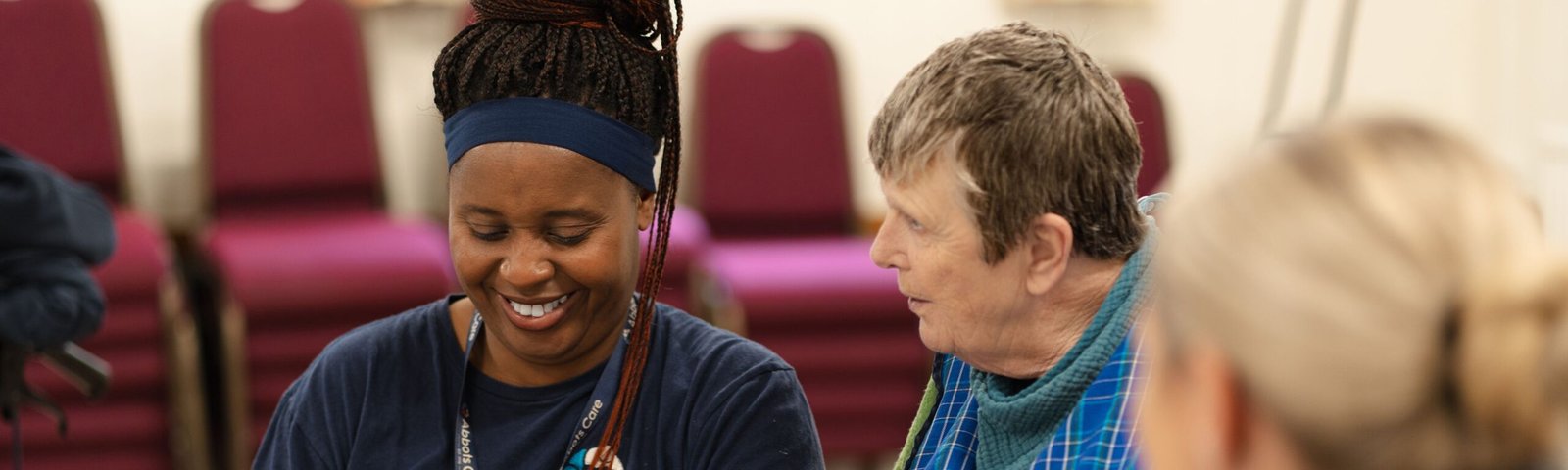 A care worker and client at a tea party