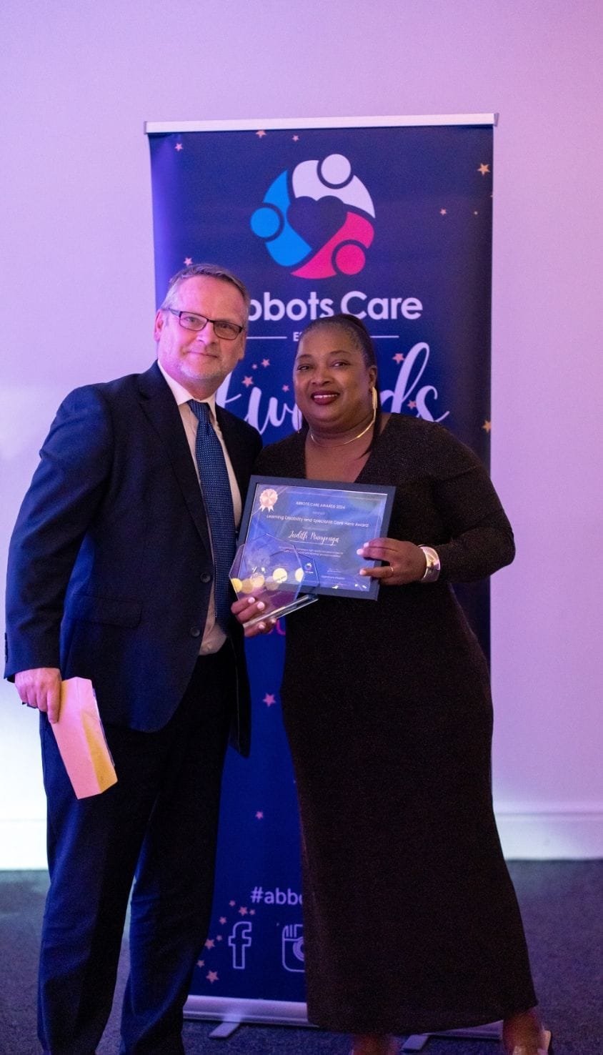 Care Worker Judith posing with her award at the Abbots Care 2024 awards