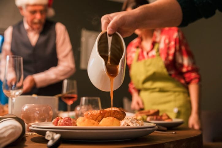 A Christmas dinner with gravy being poured onto it